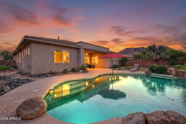 a view of a house with swimming pool and a yard
