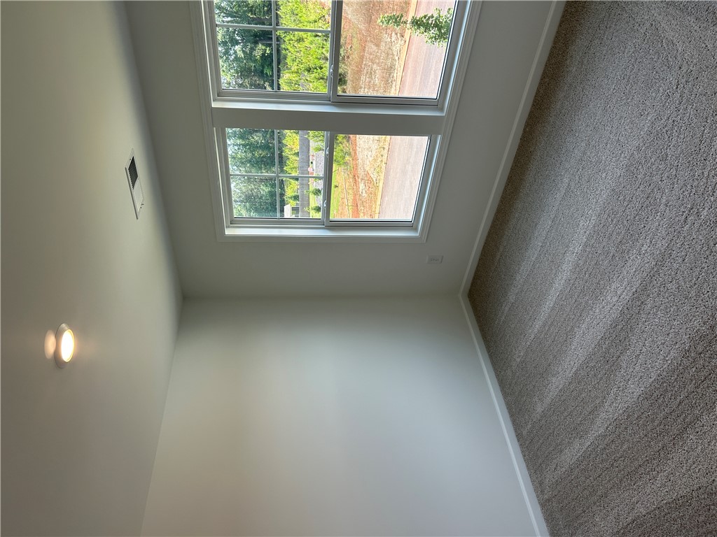 202 Bellflower Lane Pendleton, SC 29670 - Photo 17 of 27 Natural light floods this spacious room, highlighting plush carpet and clean, neutral walls.