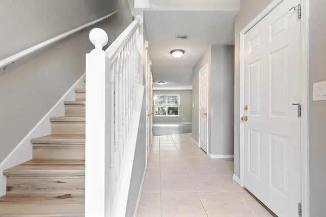 a view of a hallway with wooden floor and entryway