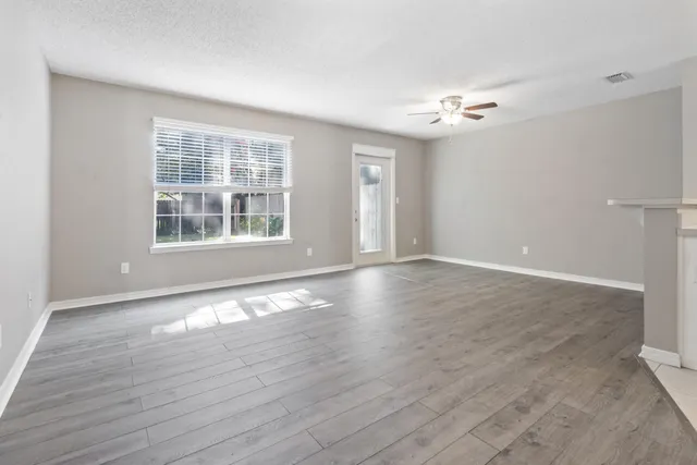 wooden floor in an empty room with a window