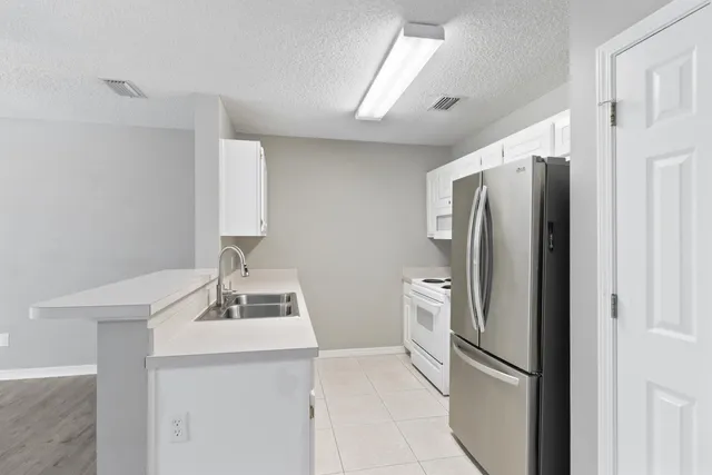 a kitchen with stainless steel appliances a refrigerator and a sink
