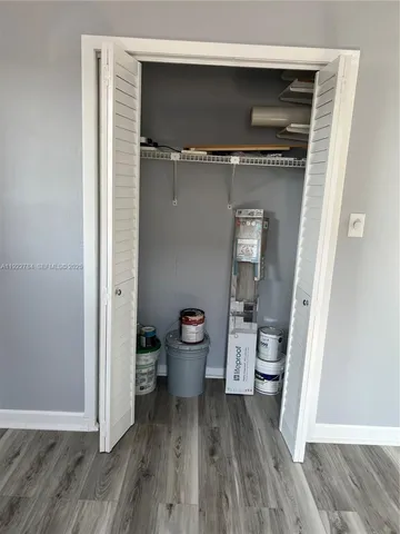 a living room with a wooden floor and furniture