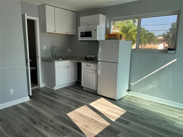 a kitchen with a refrigerator and a stove