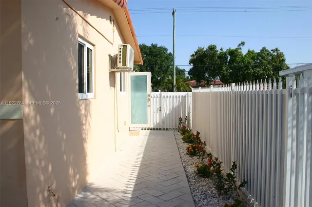 a view of a house with a flower garden