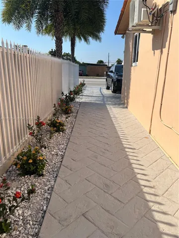 a view of a pathway with a potted plants