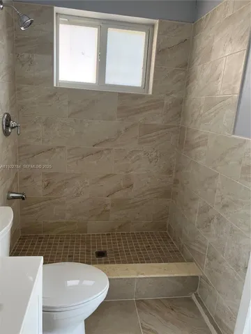 a bathroom with a toilet a bath tub and a shower