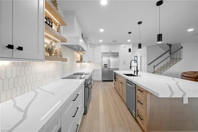 a kitchen with a sink a stove and a refrigerator