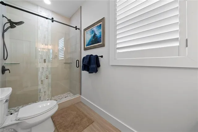 a bathroom with a toilet and a shower