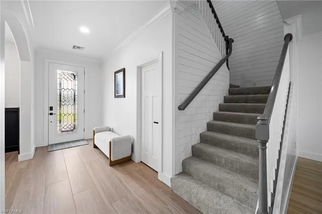 a view of a livingroom with furniture and stairs