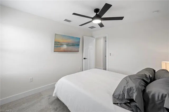 a bed room with a bed and a painting