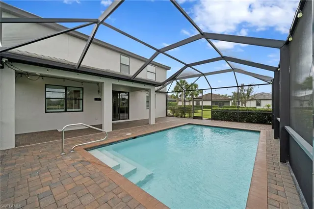 a view of a backyard with a patio and a tub