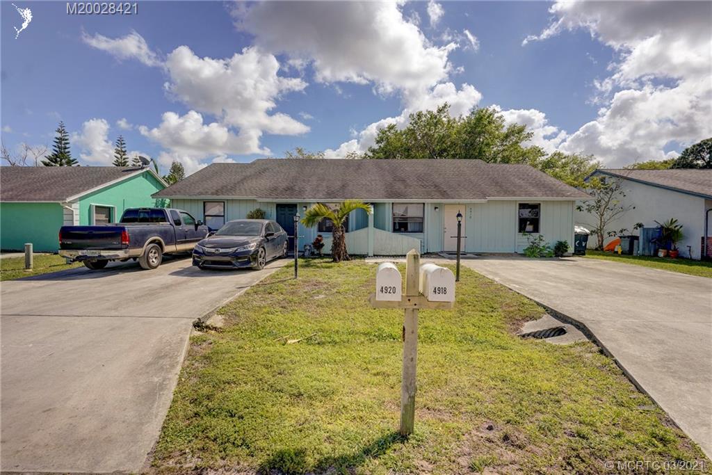 4918 Southeast Salvatori Road Stuart, FL 34997 - Photo 1 of 37 a car parked in front of house