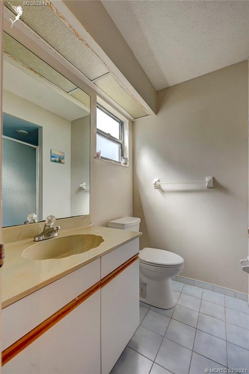 4918 Southeast Salvatori Road Stuart, FL 34997 - Photo 11 of 37 a bathroom with a sink a toilet and mirror
