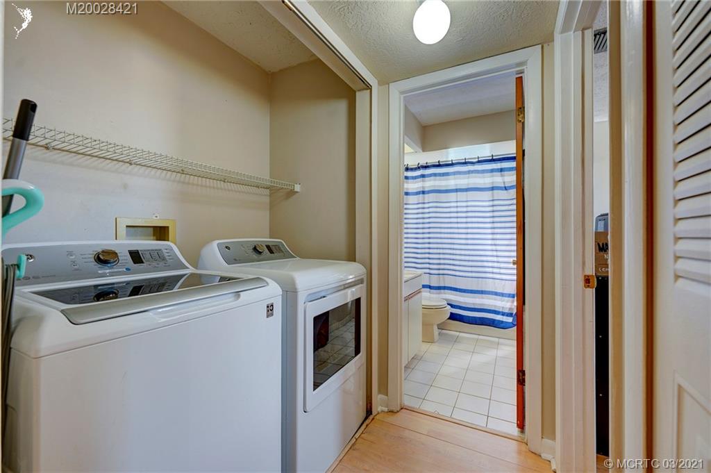 4918 Southeast Salvatori Road Stuart, FL 34997 - Photo 15 of 37 a view of storage and utility room with washer and dryer