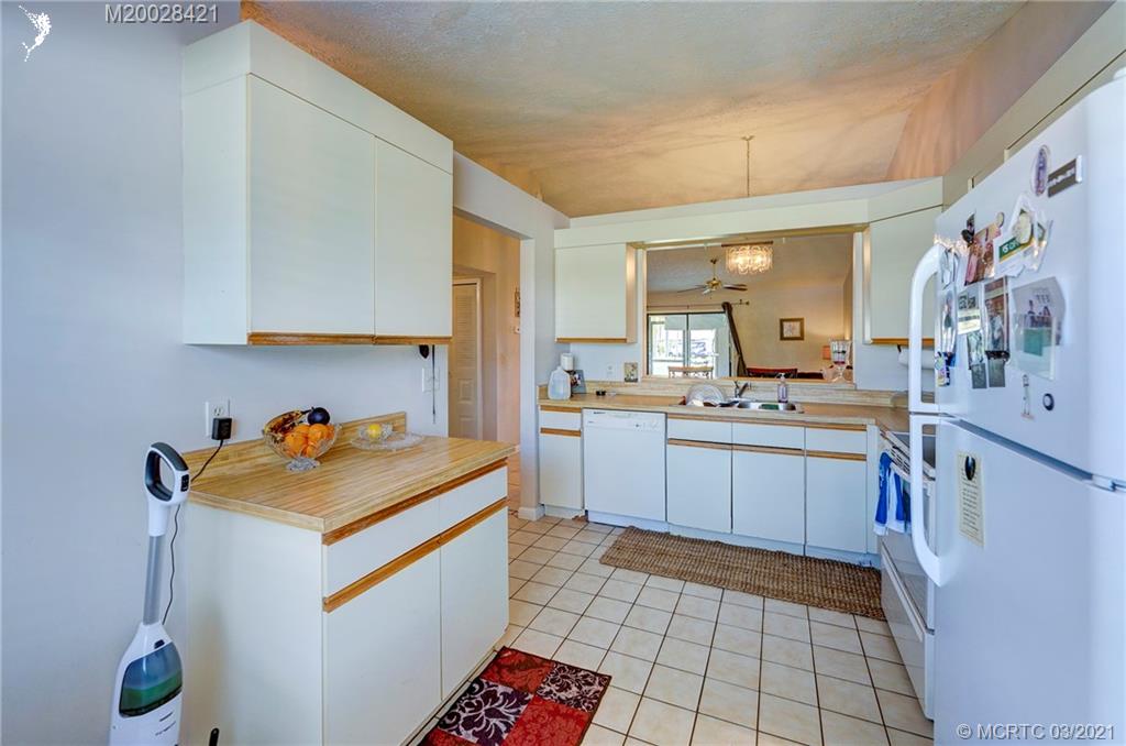 4918 Southeast Salvatori Road Stuart, FL 34997 - Photo 20 of 37 a kitchen with a sink cabinets and appliances