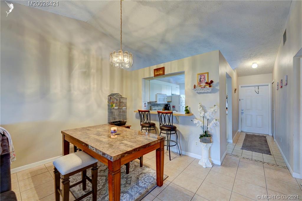 4918 Southeast Salvatori Road Stuart, FL 34997 - Photo 21 of 37 a view of a kitchen and a dining table