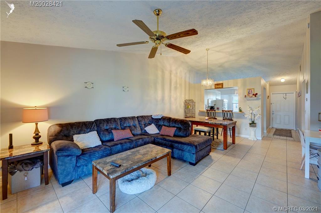 4918 Southeast Salvatori Road Stuart, FL 34997 - Photo 24 of 37 a living room with furniture and a ceiling fan