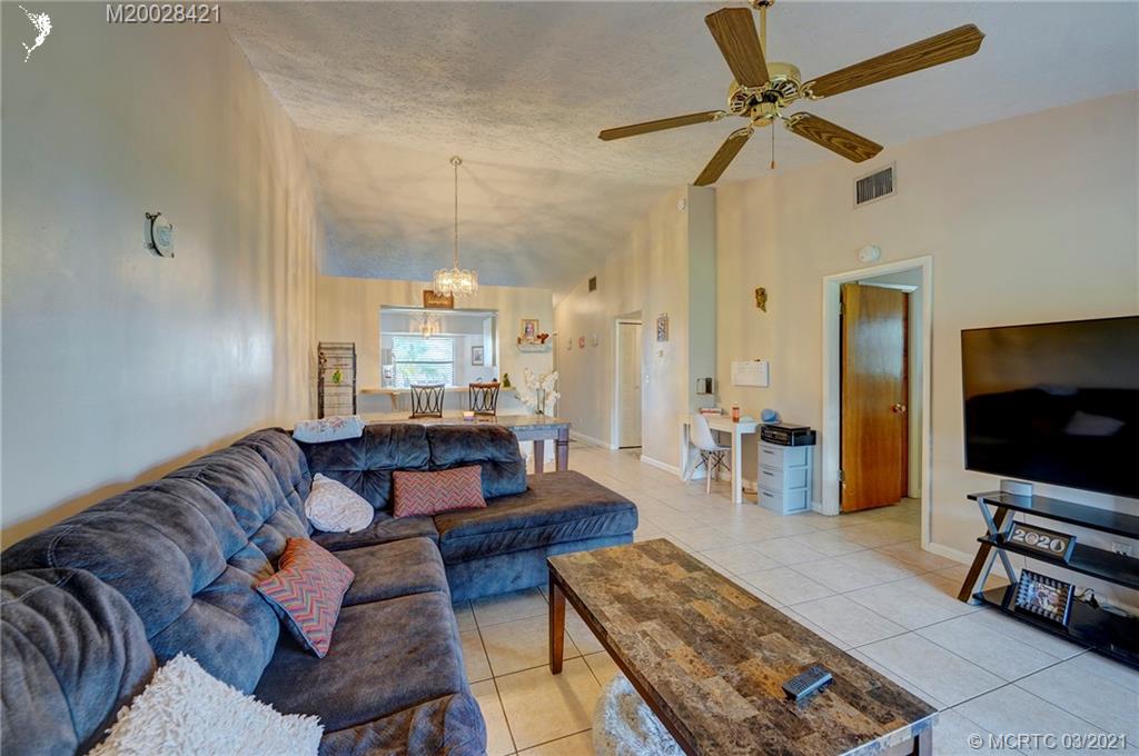 4918 Southeast Salvatori Road Stuart, FL 34997 - Photo 25 of 37 a living room with furniture and a flat screen tv