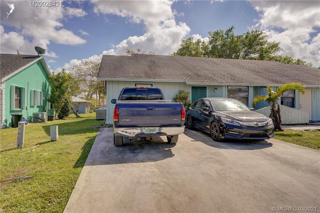 4918 Southeast Salvatori Road Stuart, FL 34997 - Photo 32 of 37 a car parked in front of a house