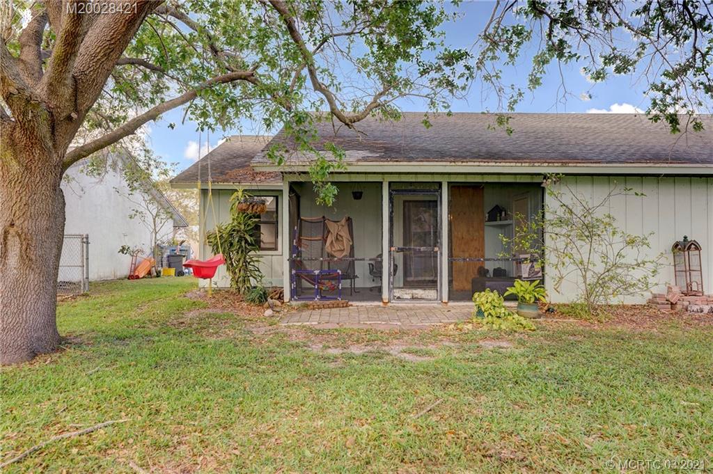 4918 Southeast Salvatori Road Stuart, FL 34997 - Photo 34 of 37 a front view of a house with a yard