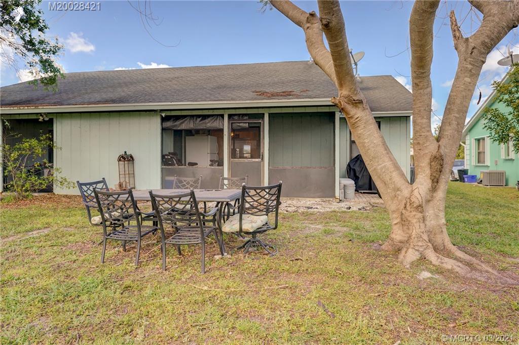 4918 Southeast Salvatori Road Stuart, FL 34997 - Photo 35 of 37 a view of a chairs and table in backyard of the house