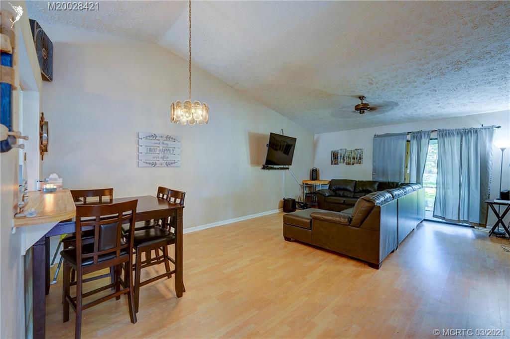 4918 Southeast Salvatori Road Stuart, FL 34997 - Photo 5 of 37 a living room with furniture and a flat screen tv
