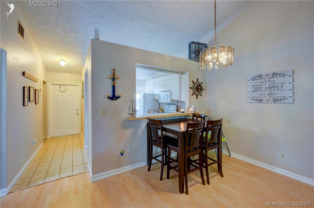 4918 Southeast Salvatori Road Stuart, FL 34997 - Photo 7 of 37 a view of a dining room with furniture and chandelier