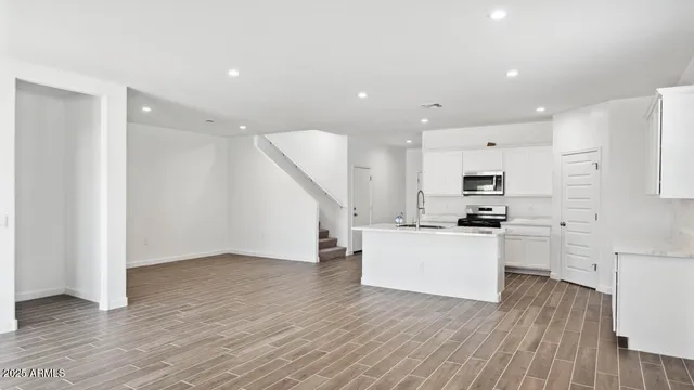 a kitchen with stainless steel appliances a refrigerator and a stove top oven