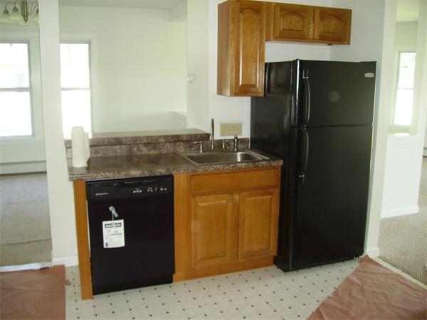633 Plantation Street Worcester, MA 01605 - Photo 11 of 24 a kitchen with a granite counter top and refrigerator