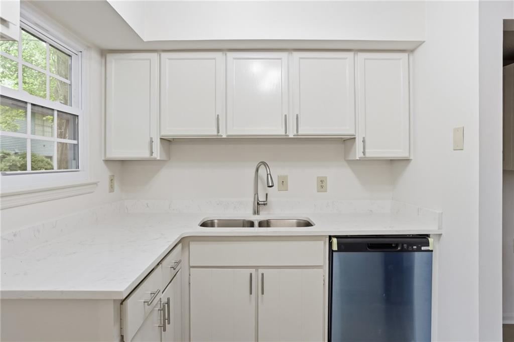 413 Promenade Court Marietta, GA 30064 - Photo 6 of 28 a kitchen with a sink cabinets and window