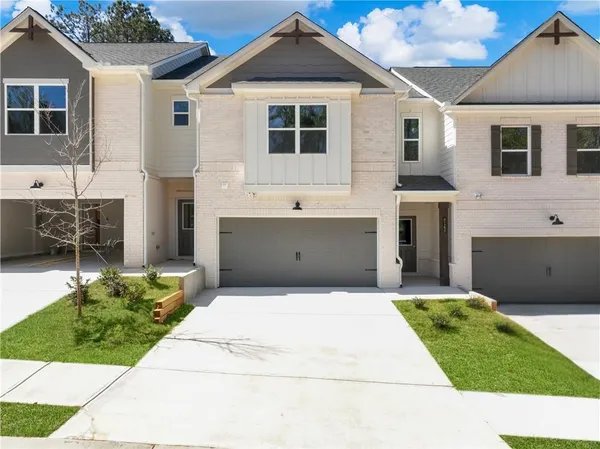 a front view of a house with a yard