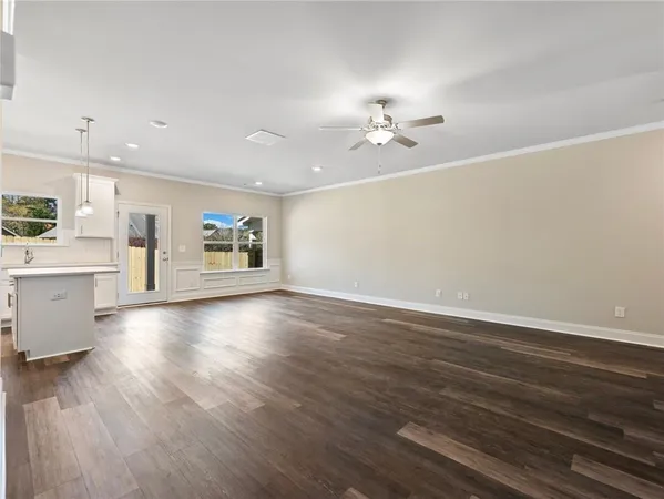 a view of a kitchen with wooden floor and a window
