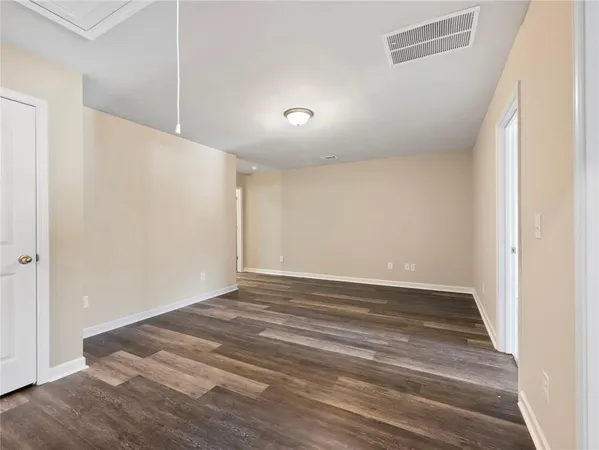 a view of a hallway with wooden floor and entryway