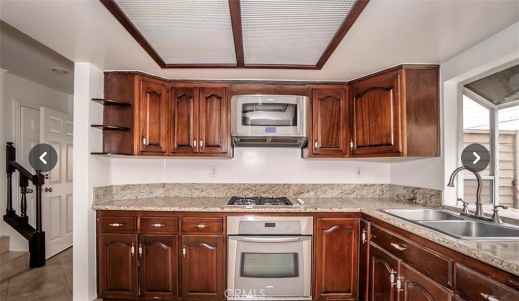 9846 California South Gate, CA 90280 - Photo 4 of 9 a kitchen with granite countertop a sink and cabinets
