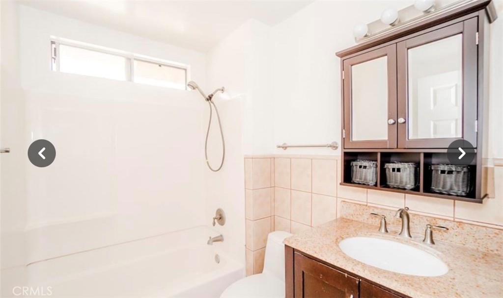 9846 California South Gate, CA 90280 - Photo 9 of 9 a bathroom with a sink and a mirror