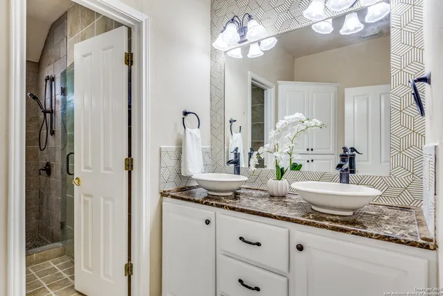 a bathroom with a granite countertop sink a toilet and a mirror