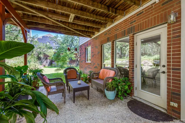a view of a porch with furniture and a yard