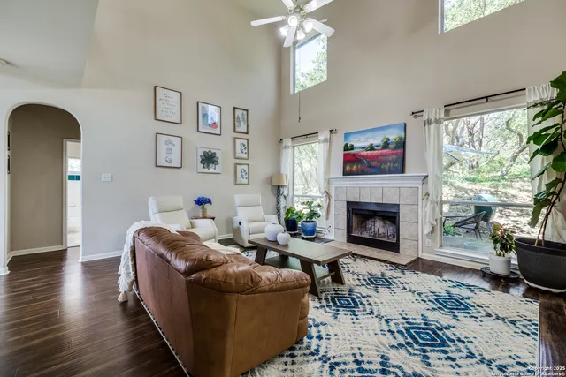 a living room with furniture a large window and a fireplace