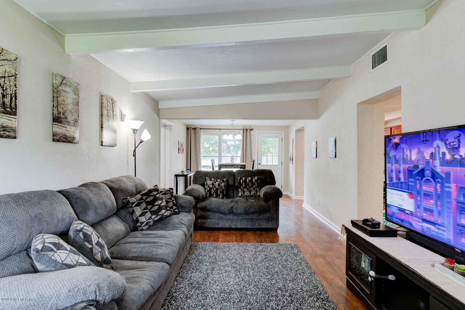 6245 Suwanee Road Jacksonville, FL 32217 - Photo 5 of 27 a living room with furniture and a flat screen tv