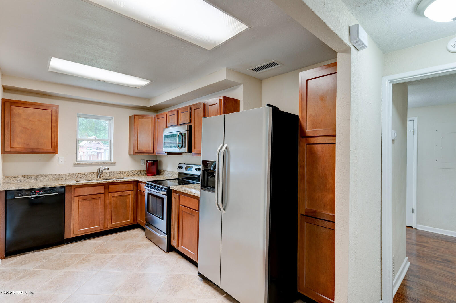 6245 Suwanee Road Jacksonville, FL 32217 - Photo 8 of 27 a kitchen with stainless steel appliances granite countertop refrigerator a stove top oven and a sink