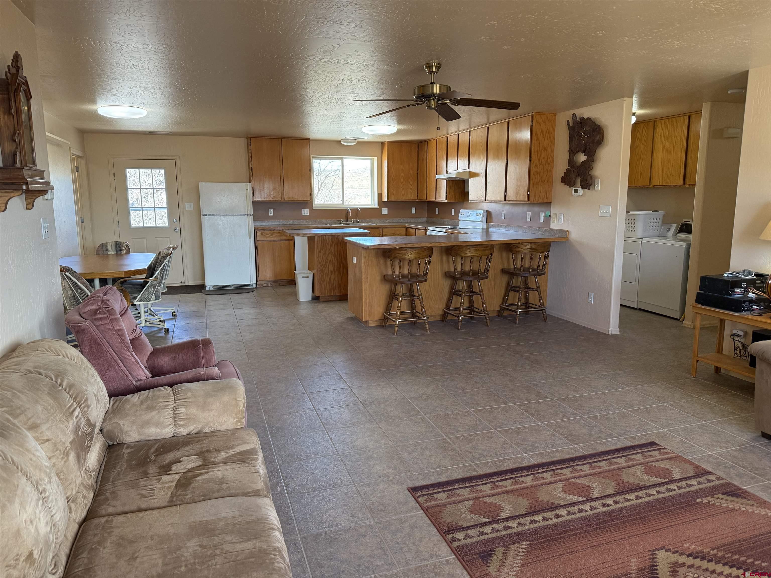 9940 2150th Road Austin, CO 81410 - Photo 4 of 44 a living room with stainless steel appliances kitchen island granite countertop furniture and a kitchen view
