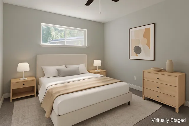 a bedroom with a bed and a painting on the wall