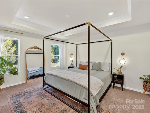 a bedroom with a bed window and a mirror