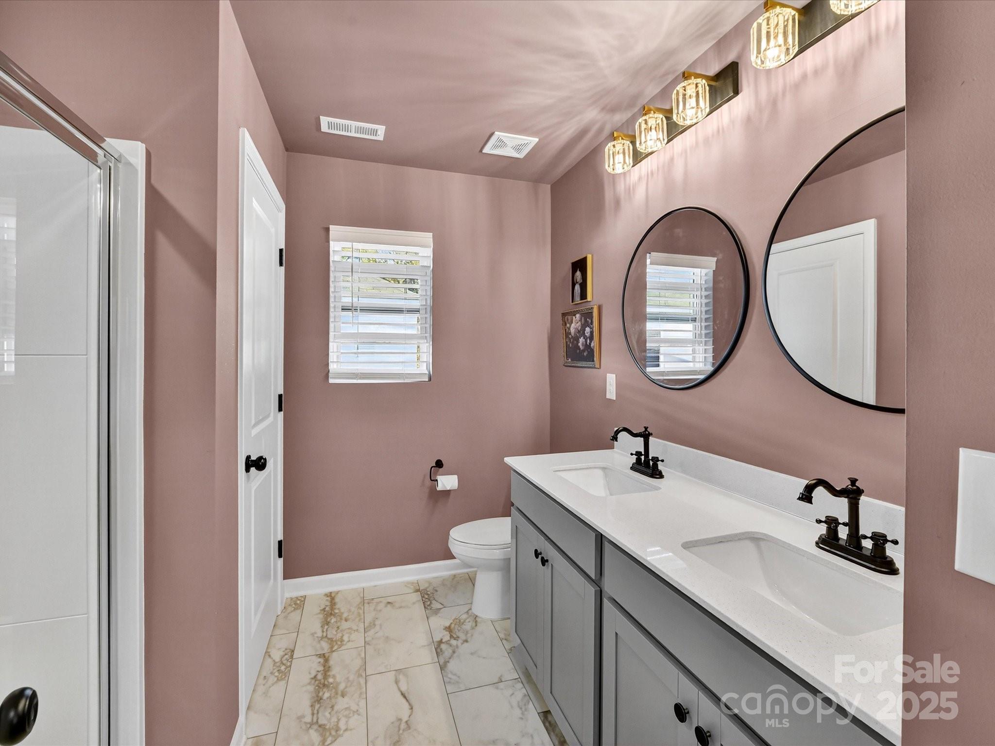 230 Quinn Road Matthews, NC 28104 - Photo 22 of 35 a bathroom with a double vanity sink mirror and a toilet