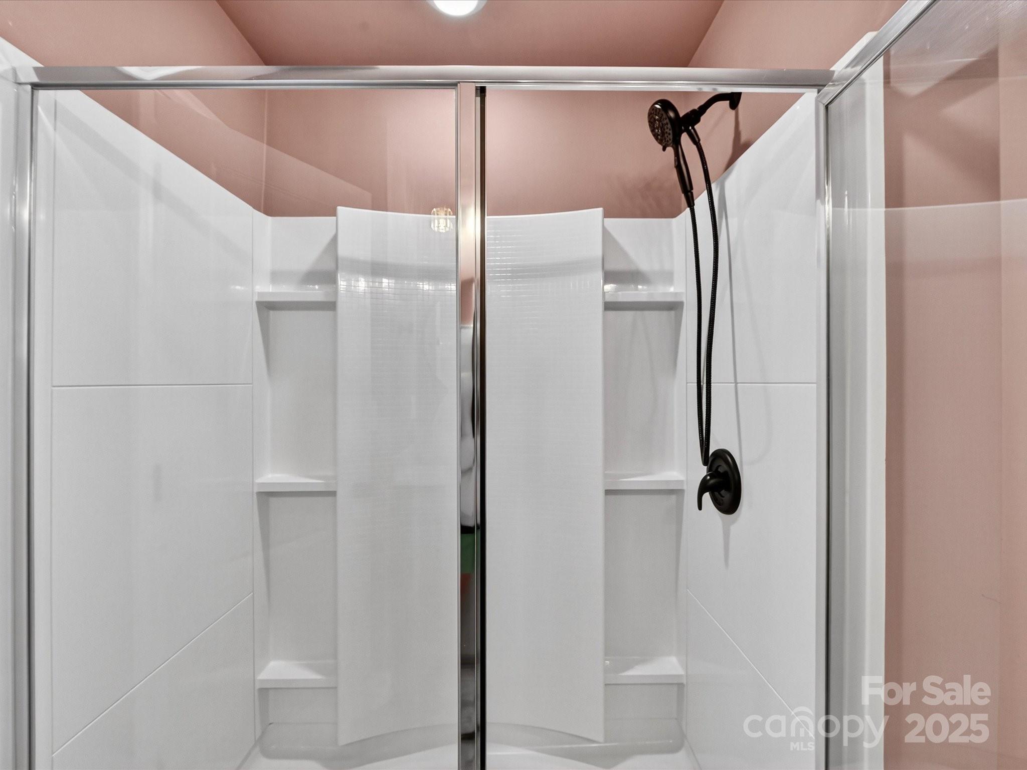 230 Quinn Road Matthews, NC 28104 - Photo 23 of 35 a bathroom with a glass door shower