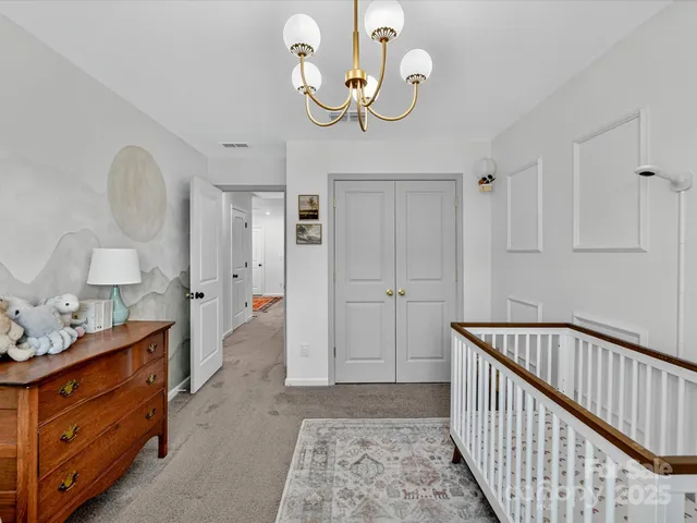 a bedroom with a bed and a lamp with window