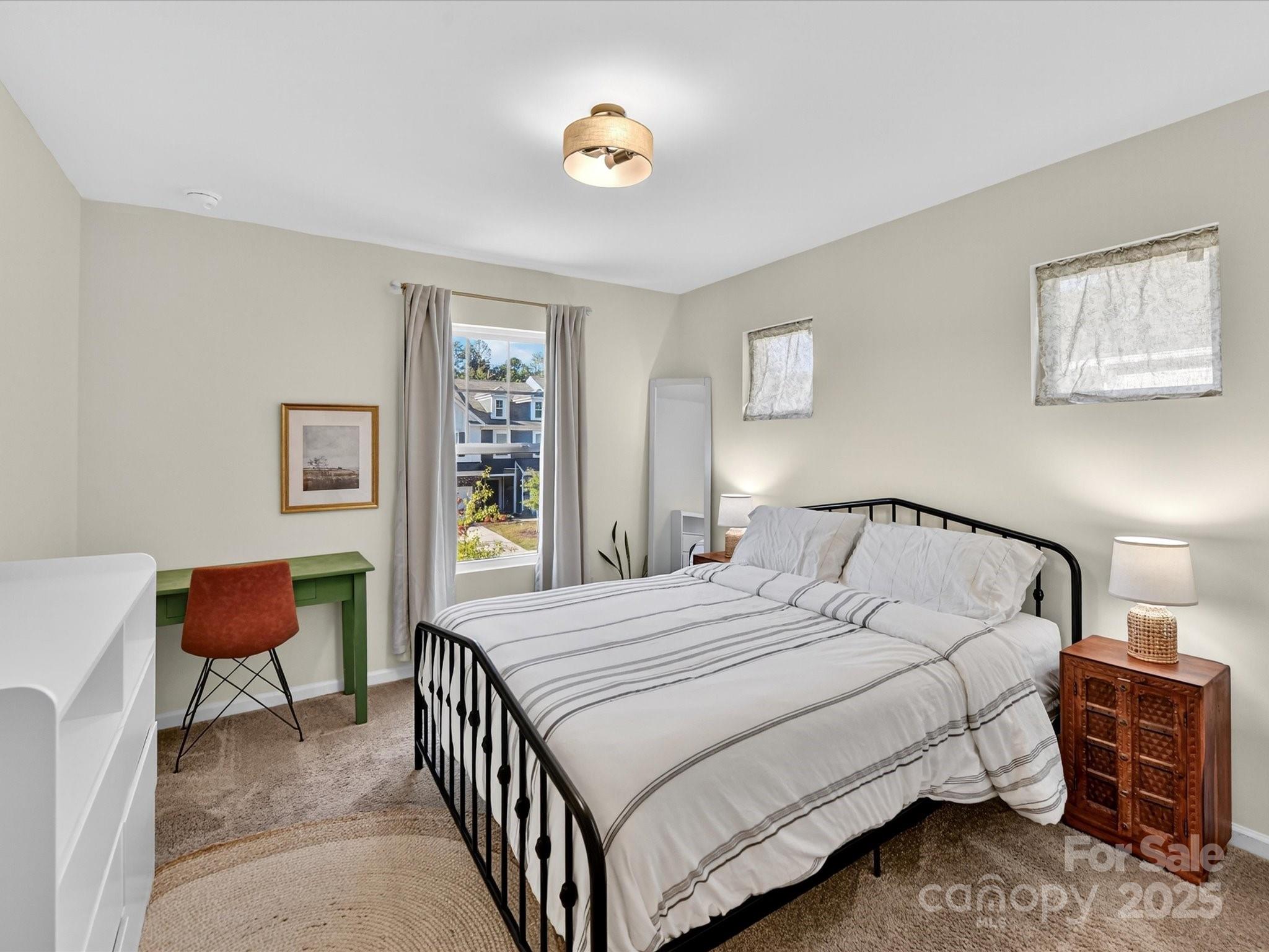 230 Quinn Road Matthews, NC 28104 - Photo 27 of 35 a bedroom with a bed and a lamp with window