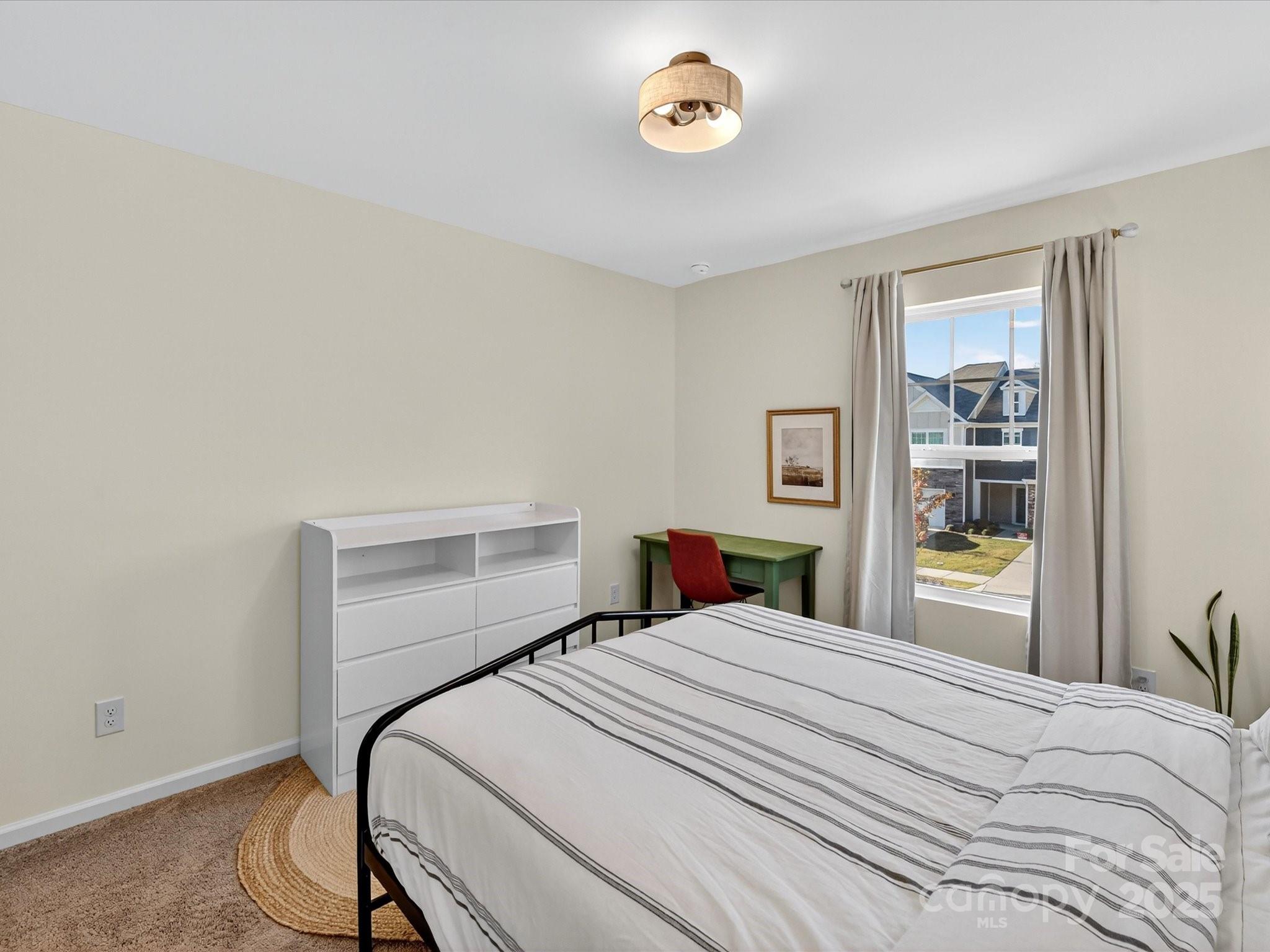 230 Quinn Road Matthews, NC 28104 - Photo 28 of 35 a bedroom with a bed and a window