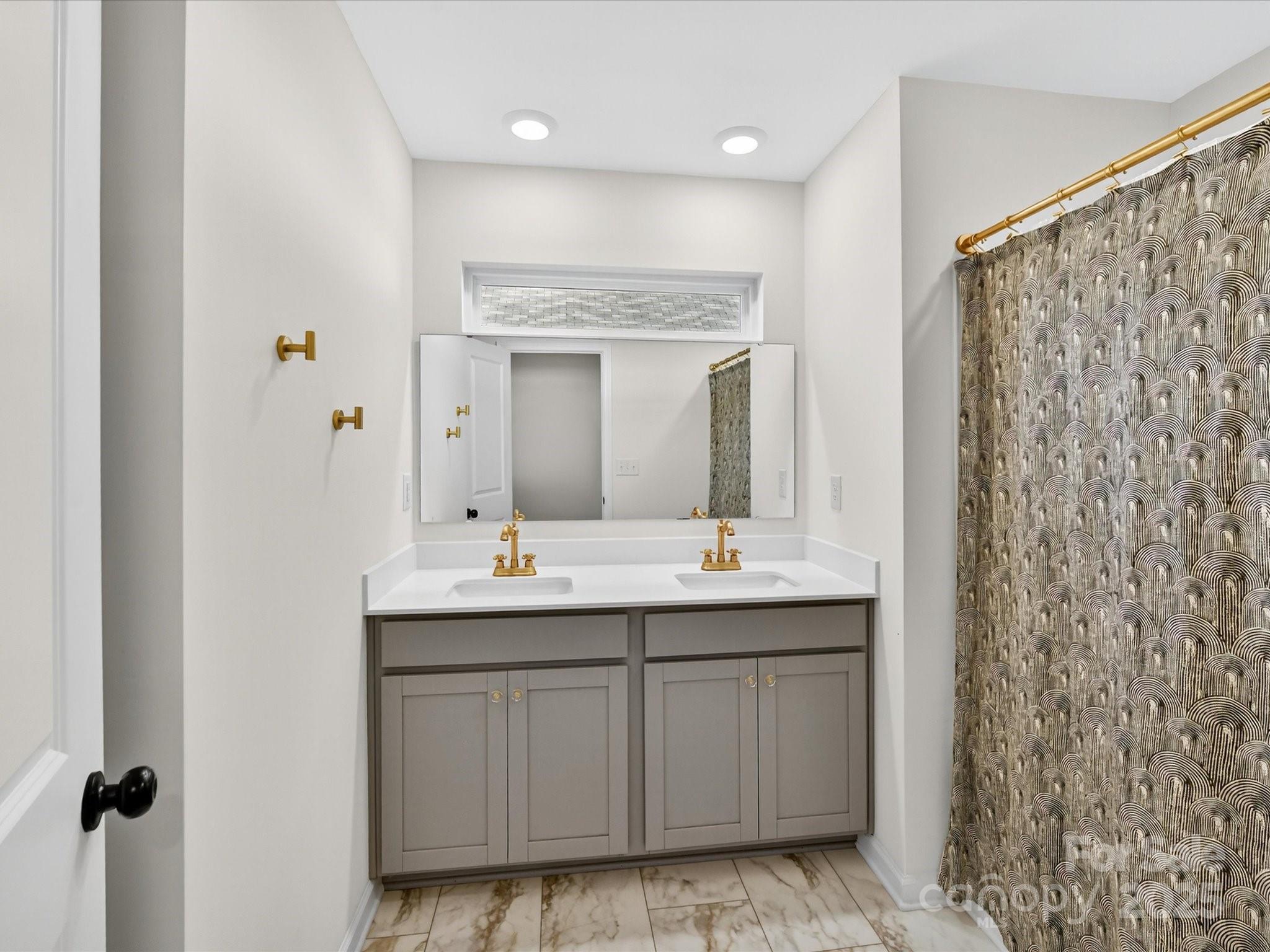 230 Quinn Road Matthews, NC 28104 - Photo 29 of 35 a bathroom with a double vanity sink and mirror