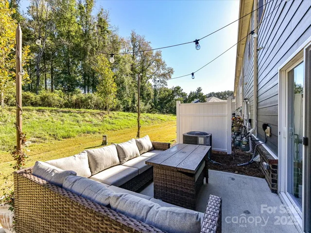 a view of a couches in a patio with a yard